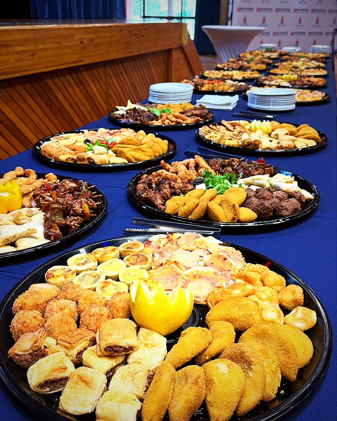Platters of samoosas, pastries and finger food laid out for a function